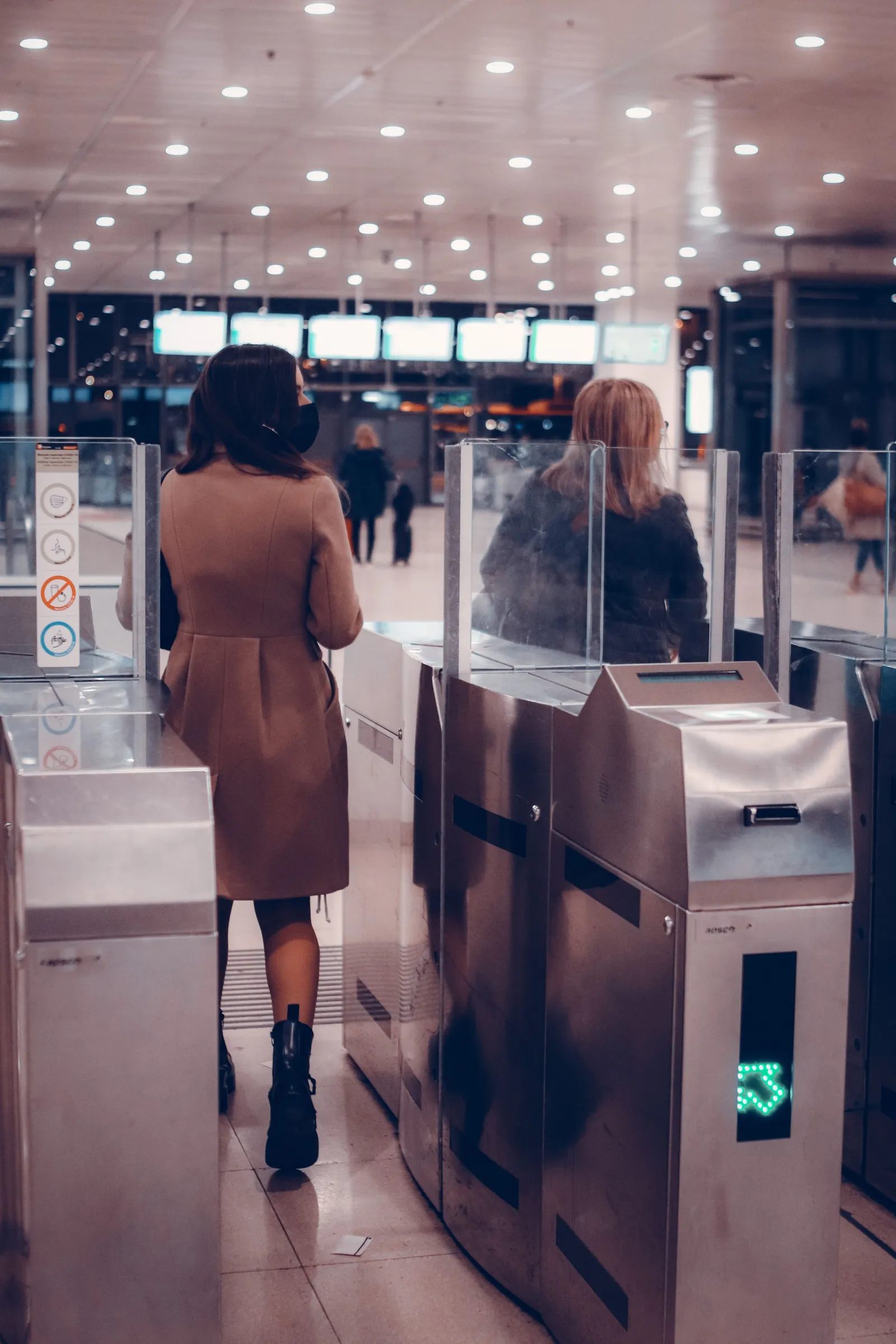 A person walking through an automated gate: access granted by a system that is not the person.