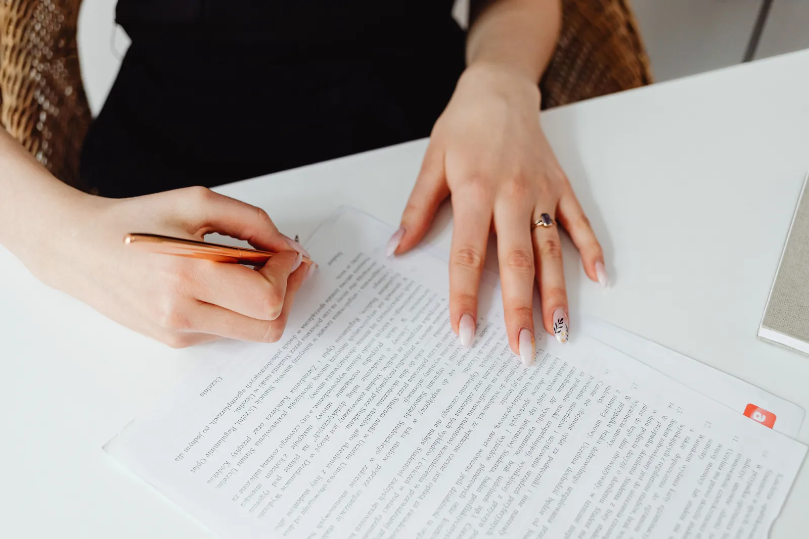 Two people at a desk with a signed agreement between them: one party proposes, a second party approves.